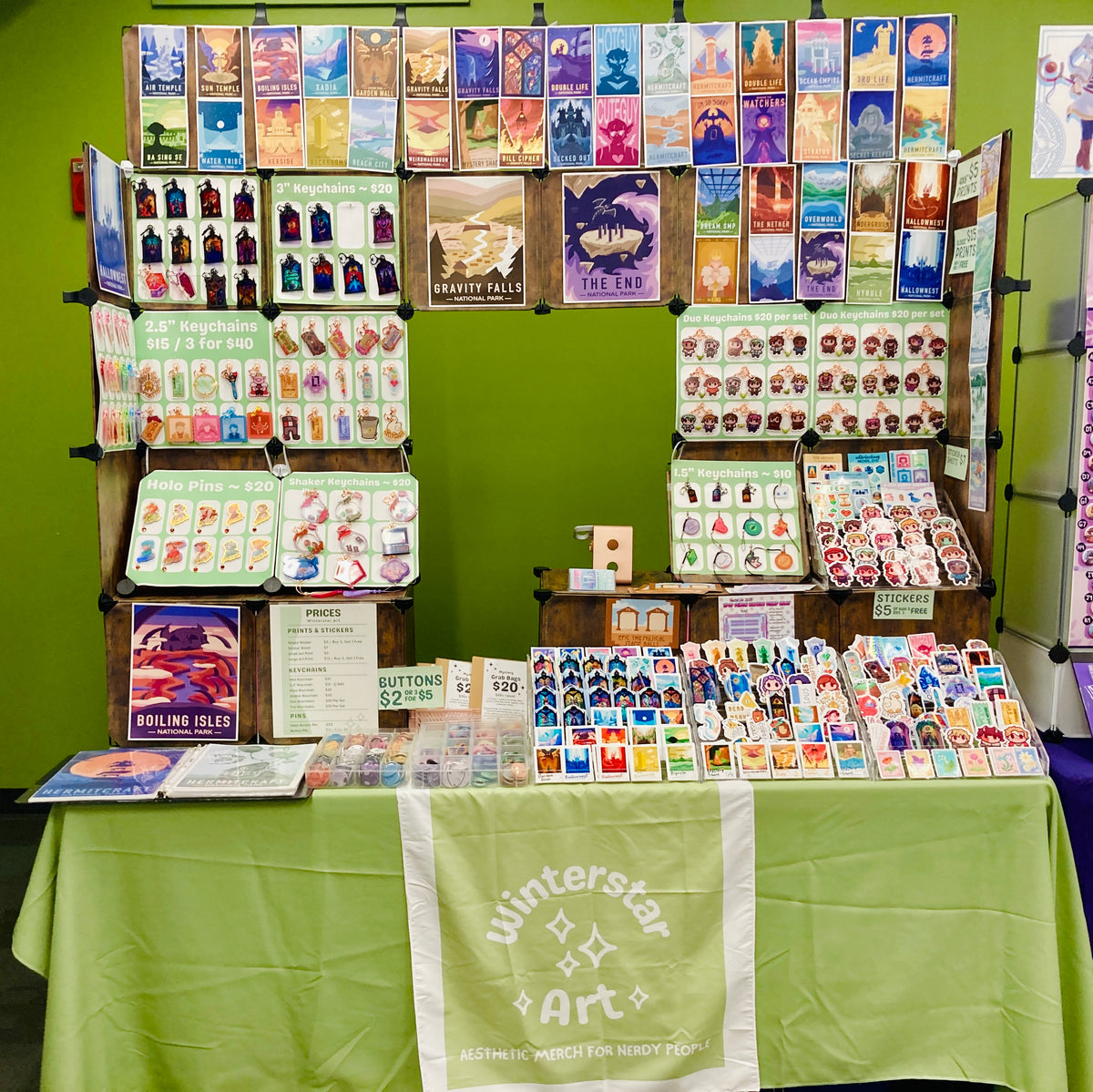 Display of various cards and merchandise on a table with a green background